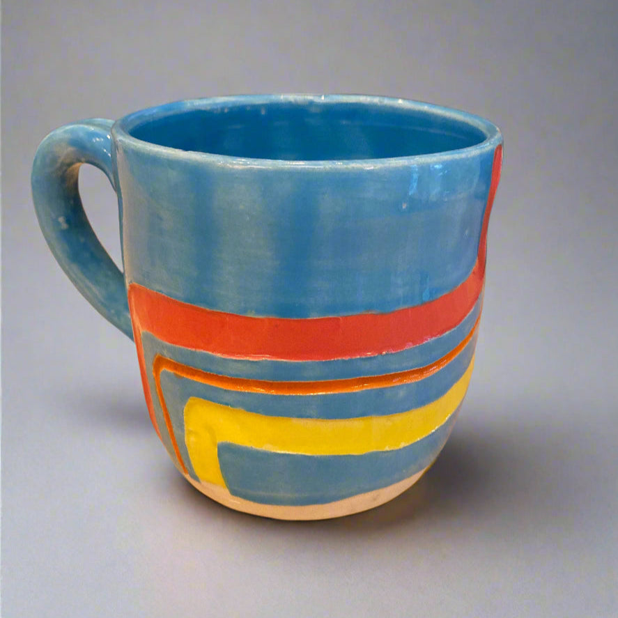 Colorful striped mug on a wooden surface