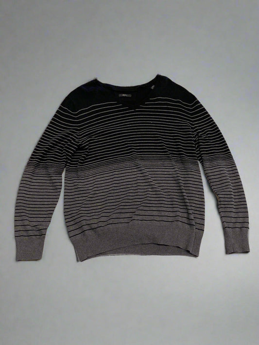 Black long-sleeve shirt on a textured beige surface